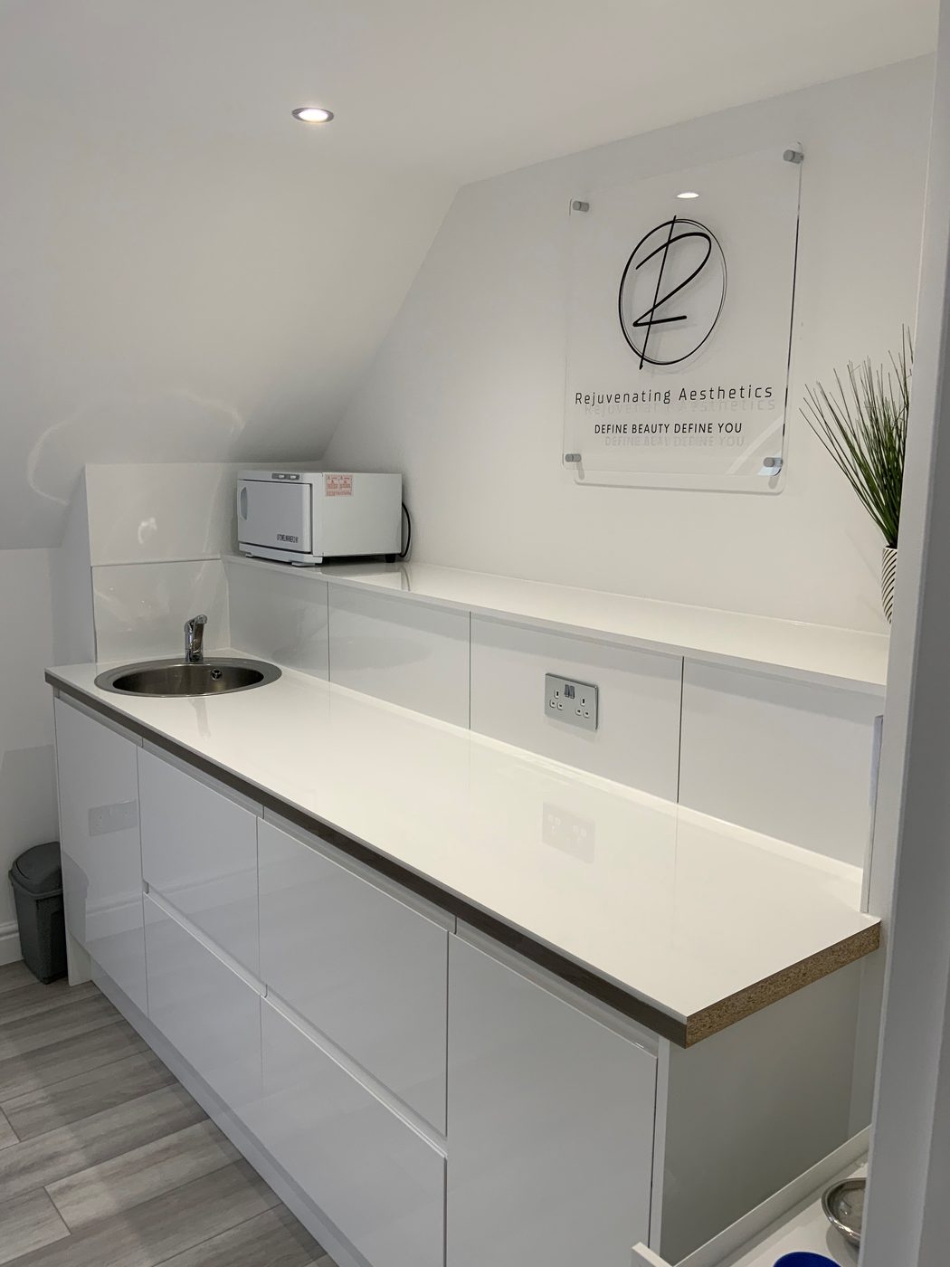 The clinic's prep area with the Rejuvenating Aesthetics sign on the wall