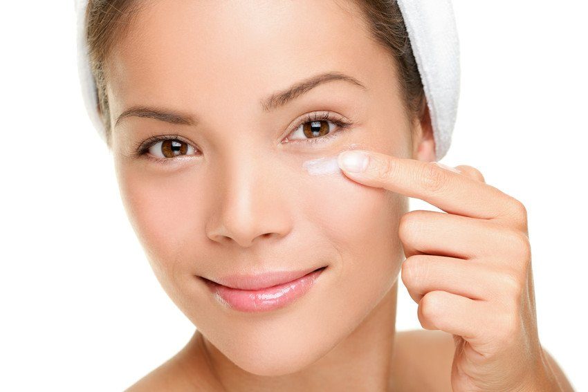Young woman applying skincare